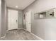 Inviting entryway with neutral tones, tile flooring, and a modern mirror at 13153 W Cottontail Ln, Peoria, AZ 85383