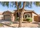 Charming home exterior with a desert landscape, showcasing a blend of stucco and inviting curb appeal at 13153 W Cottontail Ln, Peoria, AZ 85383