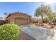 Beautiful home exterior with a well-maintained lawn and mature tree, and a two-car garage at 13153 W Cottontail Ln, Peoria, AZ 85383