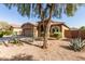 Charming single-story home with a well-manicured desert landscape and a cozy two-car garage at 13153 W Cottontail Ln, Peoria, AZ 85383