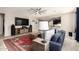 Bright living room with tile floors, ceiling fan, and a view into the kitchen at 13153 W Cottontail Ln, Peoria, AZ 85383