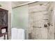 Luxurious marble shower with glass door, grab bars, and built-in shelving at 15095 N Thompson Peak Pkwy # 1005, Scottsdale, AZ 85260