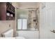 Elegant bathroom with marble shower, glass door, and built-in storage at 15095 N Thompson Peak Pkwy # 1005, Scottsdale, AZ 85260