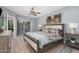 Serene bedroom featuring a king-sized bed, ceiling fan, and private balcony access at 15095 N Thompson Peak Pkwy # 1005, Scottsdale, AZ 85260