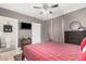 Comfortable bedroom featuring a ceiling fan, TV, and attached bathroom for added convenience at 15095 N Thompson Peak Pkwy # 1005, Scottsdale, AZ 85260