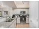 Well-equipped kitchen with white cabinets, granite counters, and stainless steel appliances at 15095 N Thompson Peak Pkwy # 1005, Scottsdale, AZ 85260