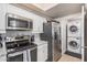 Functional kitchen with stainless steel appliances and convenient in-unit laundry area at 15095 N Thompson Peak Pkwy # 1005, Scottsdale, AZ 85260