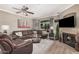 Comfortable living room with inviting leather seating, fireplace, and view to the outside at 15095 N Thompson Peak Pkwy # 1005, Scottsdale, AZ 85260