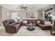 Cozy living room with leather sectional, ceiling fan, and bright window at 15095 N Thompson Peak Pkwy # 1005, Scottsdale, AZ 85260
