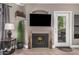 Stylish living room with cozy fireplace, decorative accents, and ample natural light at 15095 N Thompson Peak Pkwy # 1005, Scottsdale, AZ 85260