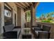 Charming covered patio area with comfortable seating and a view of lush greenery at 15095 N Thompson Peak Pkwy # 1005, Scottsdale, AZ 85260