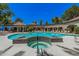 A luxurious community pool featuring a tiled hot tub, expansive deck, and multiple seating options for residents at 15095 N Thompson Peak Pkwy # 1005, Scottsdale, AZ 85260
