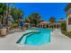 Community swimming pool with multiple seating areas, lush landscaping, and various amenities for residents to enjoy at 15095 N Thompson Peak Pkwy # 1005, Scottsdale, AZ 85260