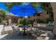 Community outdoor seating and grill near the pool at 15095 N Thompson Peak Pkwy # 1005, Scottsdale, AZ 85260