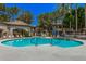 Community pool area with lounge chairs and mature landscaping at 15095 N Thompson Peak Pkwy # 1005, Scottsdale, AZ 85260