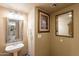 Charming powder room featuring elegant mirrors and fixtures, plus neutral paint at 15211 N 89Th Ave, Peoria, AZ 85381