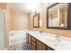 Inviting bathroom features double sinks, spacious vanity, and a large soaking tub at 15211 N 89Th Ave, Peoria, AZ 85381
