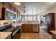 Kitchen featuring stainless steel appliances and brown cabinets at 15211 N 89Th Ave, Peoria, AZ 85381
