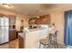 Bright kitchen features stainless steel appliances and a breakfast bar with seating for casual dining at 15211 N 89Th Ave, Peoria, AZ 85381