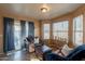 Living room featuring leather sofas, a table, and access to patio at 15211 N 89Th Ave, Peoria, AZ 85381