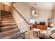 Inviting living room with high ceilings, tile floors, and a staircase leading to the upper level at 15211 N 89Th Ave, Peoria, AZ 85381