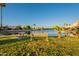 Waterfront homes featuring a picnic table and bench overlooking the serene pond at 15211 N 89Th Ave, Peoria, AZ 85381