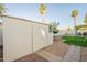 Backyard featuring storage shed, green grass, desert landscaping, and palm trees at 15211 N 89Th Ave, Peoria, AZ 85381