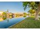 Scenic waterfront property with palm trees lining the canal in a charming community at 15211 N 89Th Ave, Peoria, AZ 85381