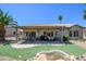 Outdoor entertaining area and lovely backyard retreat complete with a water feature and desert landscaping at 15658 W Arbor Trl, Surprise, AZ 85374