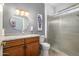 Bathroom featuring a wood vanity, granite counters, and glass-enclosed shower at 15658 W Arbor Trl, Surprise, AZ 85374