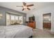 Bedroom with ceiling fan and bay window and en suite bath at 15658 W Arbor Trl, Surprise, AZ 85374
