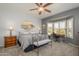 Bedroom with ceiling fan, bay window and a seating area at 15658 W Arbor Trl, Surprise, AZ 85374