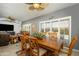 Dining room with ceiling fan and window overlooking the backyard with natural light at 15658 W Arbor Trl, Surprise, AZ 85374