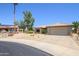 Eye-catching one-story home featuring desert landscaping and a beige exterior with a two-car garage at 15658 W Arbor Trl, Surprise, AZ 85374