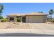 Charming single-story home featuring a desert landscape, beige exterior paint, and a two-car garage at 15658 W Arbor Trl, Surprise, AZ 85374