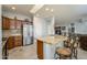 Spacious kitchen with stainless steel appliances and granite countertop island and breakfast bar at 15658 W Arbor Trl, Surprise, AZ 85374