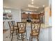Open kitchen with granite countertops, stainless steel appliances, and bar seating for a cozy feel at 15658 W Arbor Trl, Surprise, AZ 85374