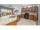 Bright kitchen features stainless appliances, granite counters, and wooden cabinetry at 15658 W Arbor Trl, Surprise, AZ 85374