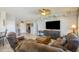 Spacious living room featuring a ceiling fan, stylish furnishings, and a large TV at 15658 W Arbor Trl, Surprise, AZ 85374