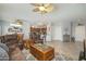 Spacious living room area featuring tile flooring, recessed lighting, ceiling fan, and comfortable leather furniture at 15658 W Arbor Trl, Surprise, AZ 85374