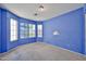 Neutral-toned bedroom with carpeted floors and large windows for ample natural light at 16242 W Caribbean Ln, Surprise, AZ 85379