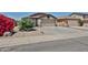 Charming single-story home with a two-car garage and low-maintenance desert landscaping at 16242 W Caribbean Ln, Surprise, AZ 85379