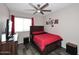 Bedroom featuring dark-stained wood furnishings, a ceiling fan, and red accents at 1640 W Gail Dr, Chandler, AZ 85224
