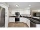 Kitchen with white cabinets, black countertops, stainless steel appliances, and tile flooring at 1640 W Gail Dr, Chandler, AZ 85224