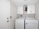 Practical laundry room with washer, dryer, storage, and overhead fan at 1640 W Gail Dr, Chandler, AZ 85224