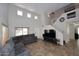 Spacious living room with a large sectional sofa, high ceilings, neutral tones, and tile flooring at 1640 W Gail Dr, Chandler, AZ 85224