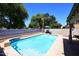 Backyard pool features a basketball hoop, mature trees, and privacy wall at 1640 W Gail Dr, Chandler, AZ 85224