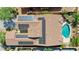 Home with solar panels and a backyard pool surrounded by lush landscaping at 18108 W Thunderhill Pl, Goodyear, AZ 85338