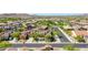 Picturesque community with solar panels, lush greenery, and mountain backdrop at 18108 W Thunderhill Pl, Goodyear, AZ 85338
