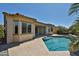 A view of the luxurious pool with a spa and landscaped backyard from the home's rear exterior at 18108 W Thunderhill Pl, Goodyear, AZ 85338